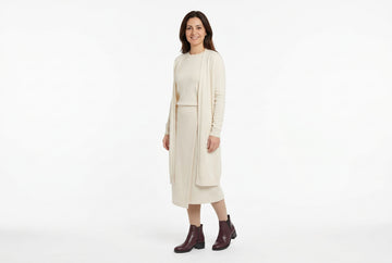 Stivaletti Melluso donna indossati con cardigan lungo, maglia girocollo in jersey di lana e gonna midi a portafoglio panna. Outfit 1